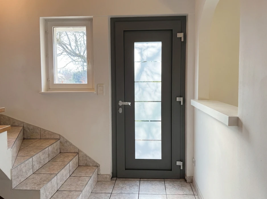 Portail coulissant aluminium anthracite (RAL 7016) avec lames horizontales pleines, monté sur rails au sol