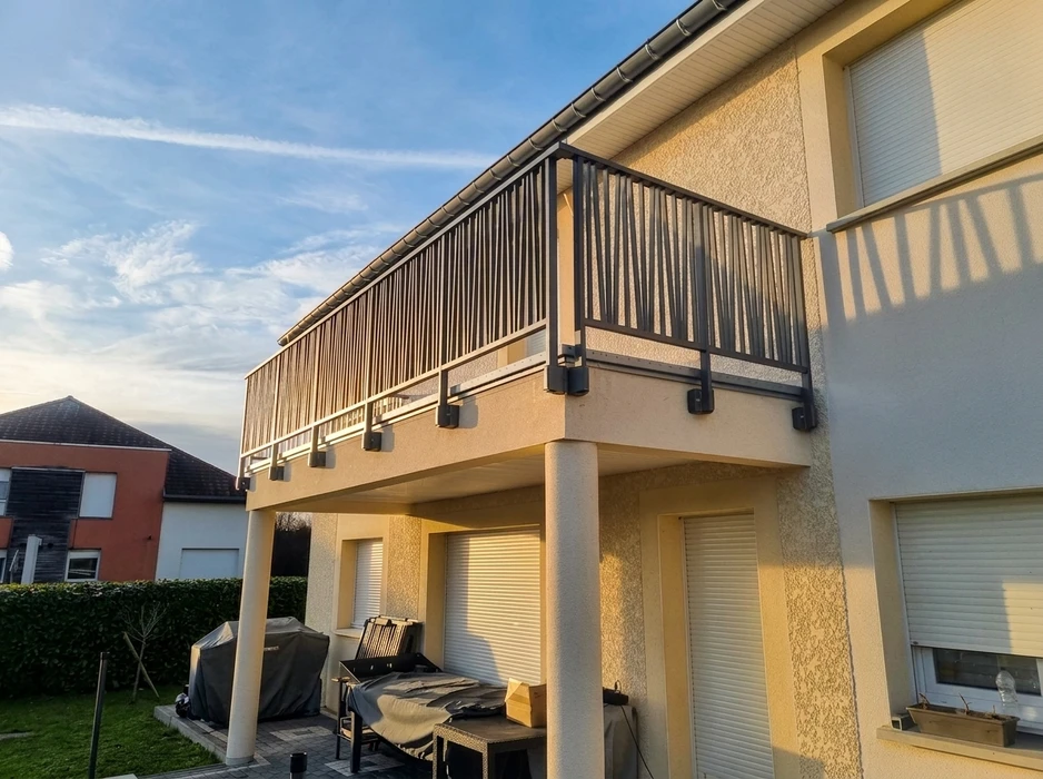 Villa bourgeoise de style Belle Époque, façade blanche avec volets bruns, tourelle à toit en poivrière, balcons en bois à balustres, terrasse avec balustrade en pierre