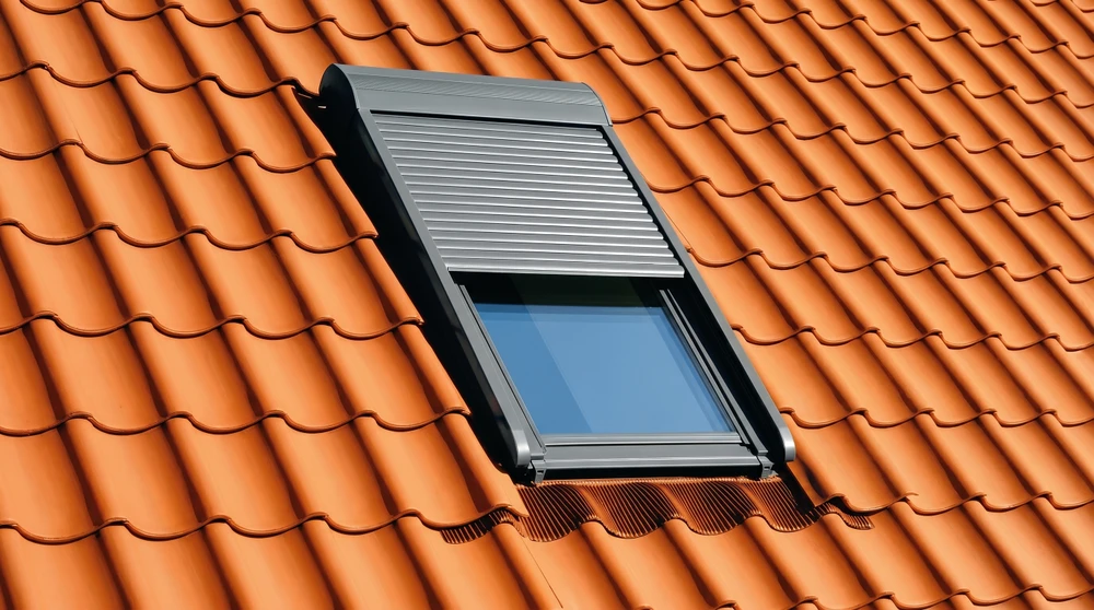 Intérieur lumineux avec triple fenêtre de toit en pente, cadres blancs en PVC, vitrage clair
